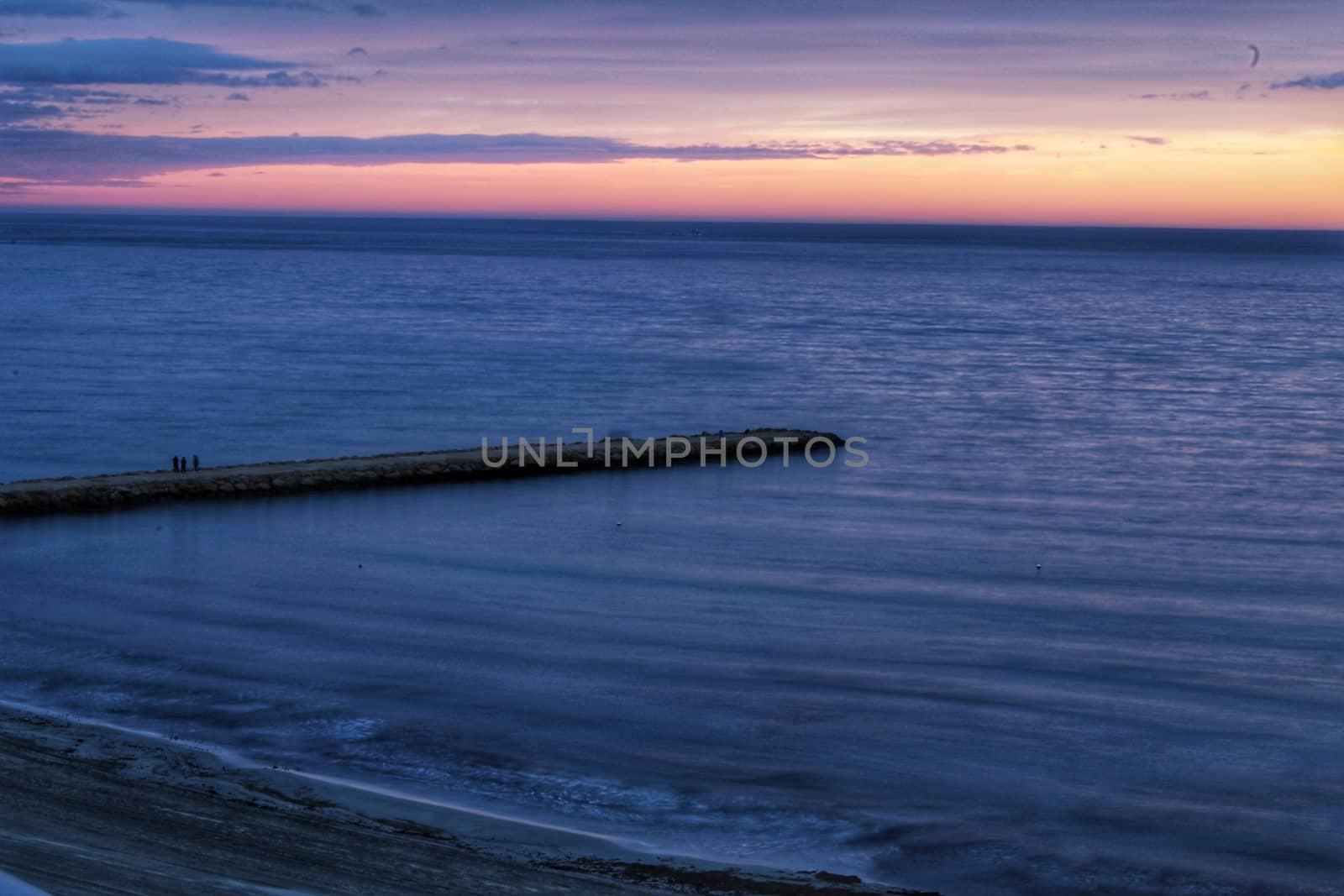 Spectacular and colorful sunset in the bay of Santa Pola, Alicante, Spain in autumn