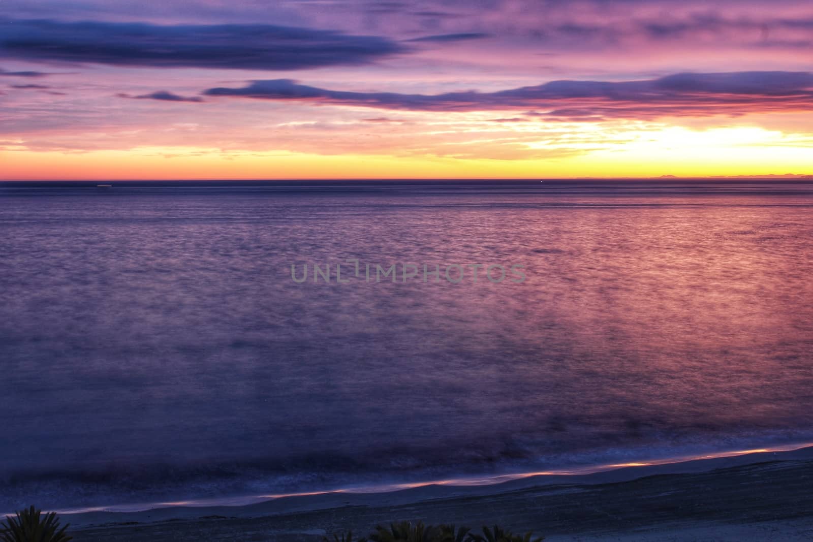 Spectacular and colorful sunset in the bay of Santa Pola, Alicante, Spain in autumn