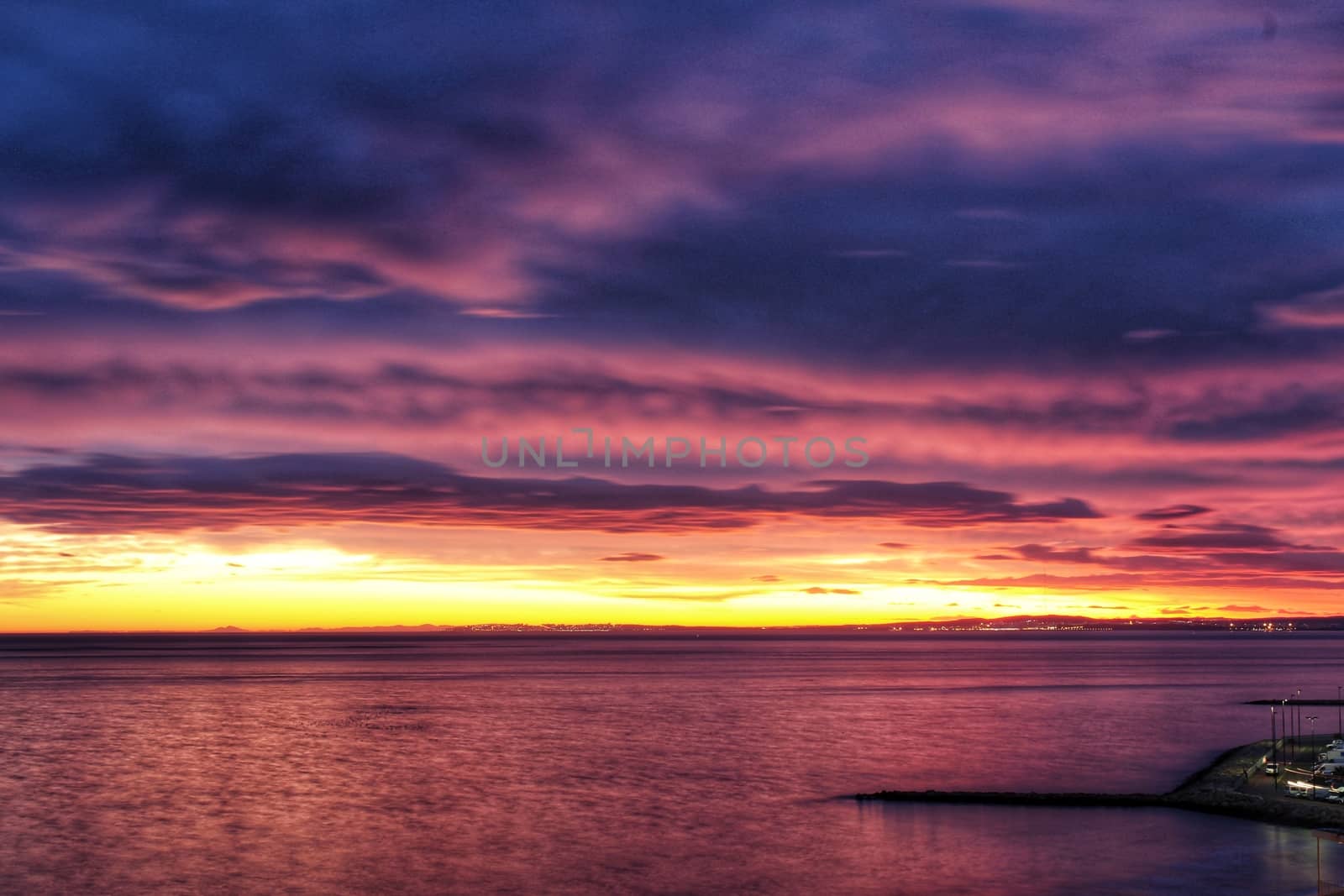 Spectacular and colorful sunset in the bay of Santa Pola, Alicante, Spain in autumn