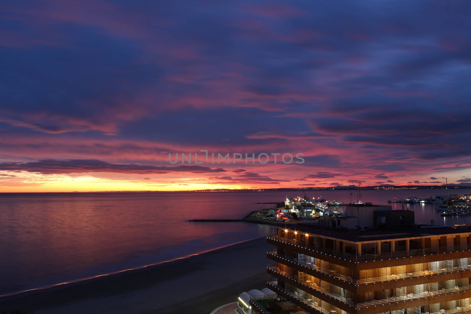 Spectacular and colorful sunset in the bay of Santa Pola, Alicante, Spain in autumn