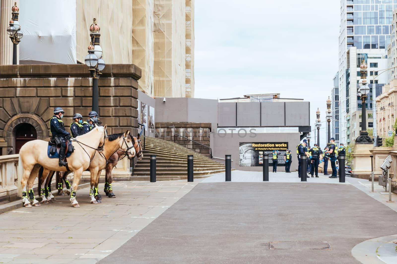 Melbourne, Australia - October 18, 2020: Victoria police patrol Melbourne CBD streets and Parliament on horseback, checking on people during the Coronavirus pandemic and associated lockdown.