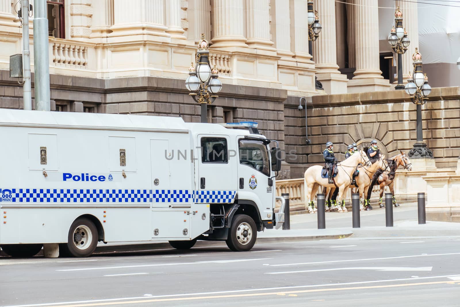 Melbourne, Australia - October 18, 2020: Victoria police patrol Melbourne CBD streets and Parliament on horseback, checking on people during the Coronavirus pandemic and associated lockdown.