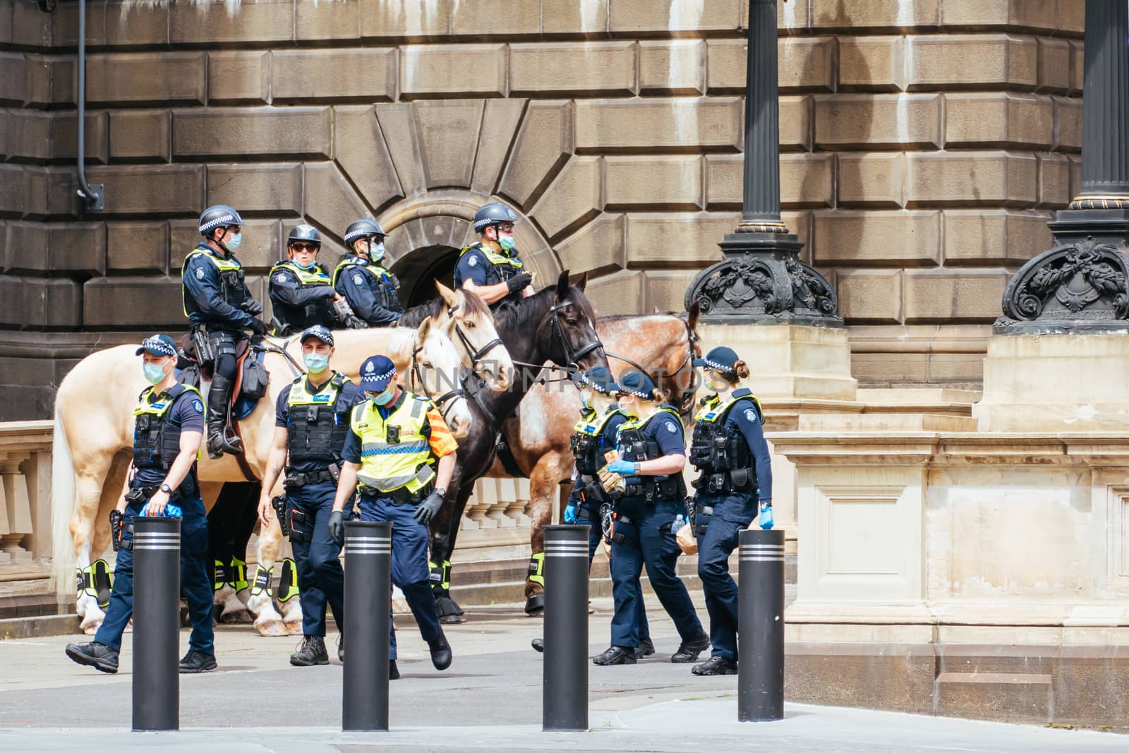 Melbourne, Australia - October 18, 2020: Victoria police patrol Melbourne CBD streets and Parliament on horseback, checking on people during the Coronavirus pandemic and associated lockdown.