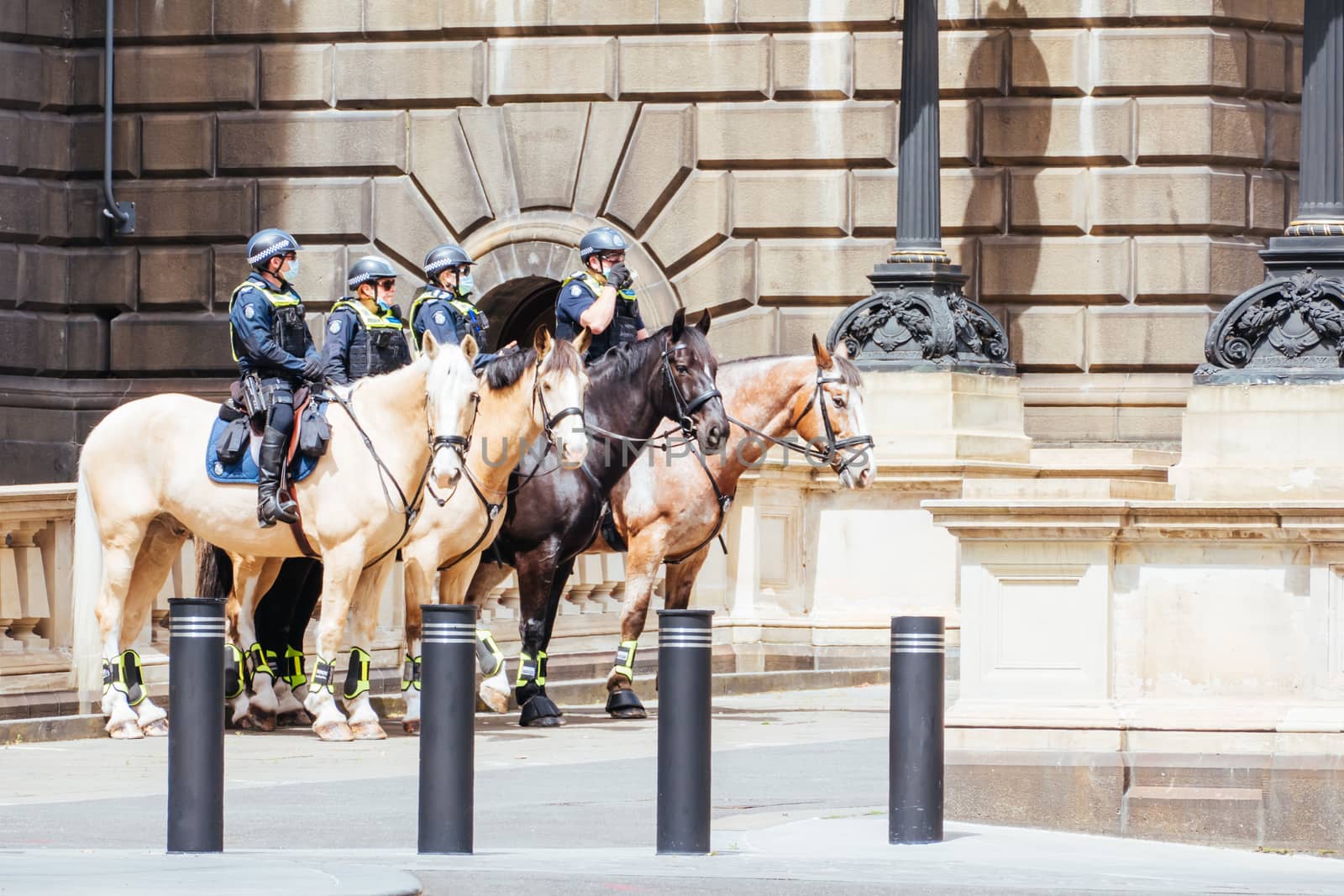 Melbourne, Australia - October 18, 2020: Victoria police patrol Melbourne CBD streets and Parliament on horseback, checking on people during the Coronavirus pandemic and associated lockdown.