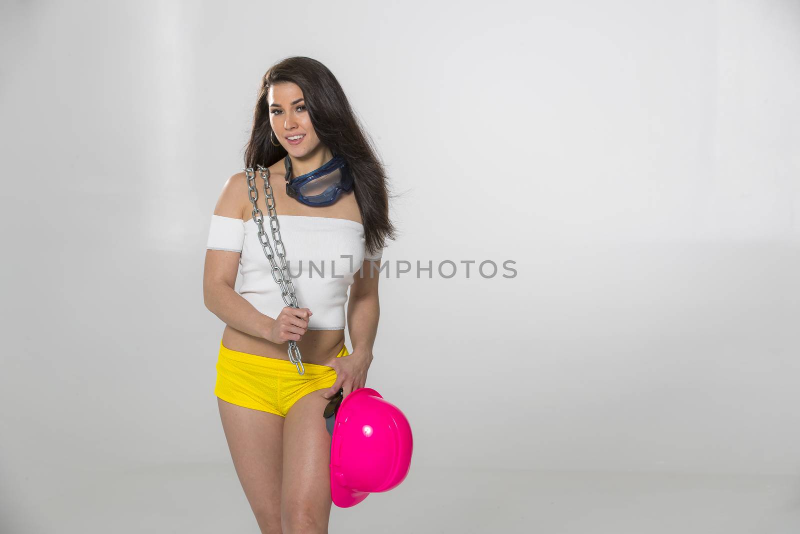 A gorgeous brunette model posing in a studio environment