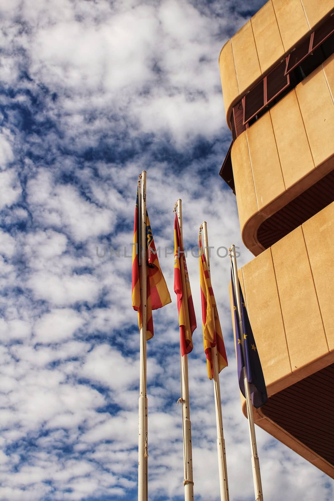 Santa Pola, Spain- February 16, 2018: Constitutional flags of Spain and Europe at the city hall in a cloudy day