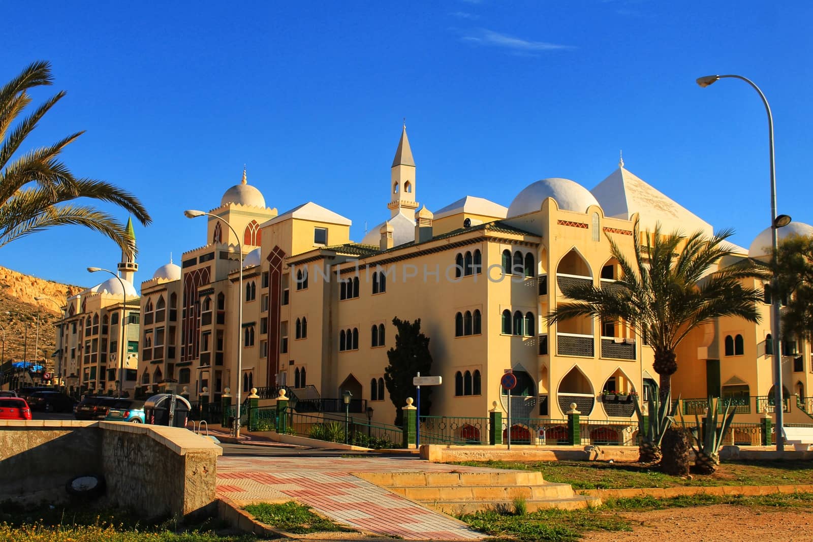 Santa Pola, Spain- February 20, 2018: Beautiful and colorful Arab-style urbanization on the coast of Santa Pola, Alicante, in a sunny day under blue sky