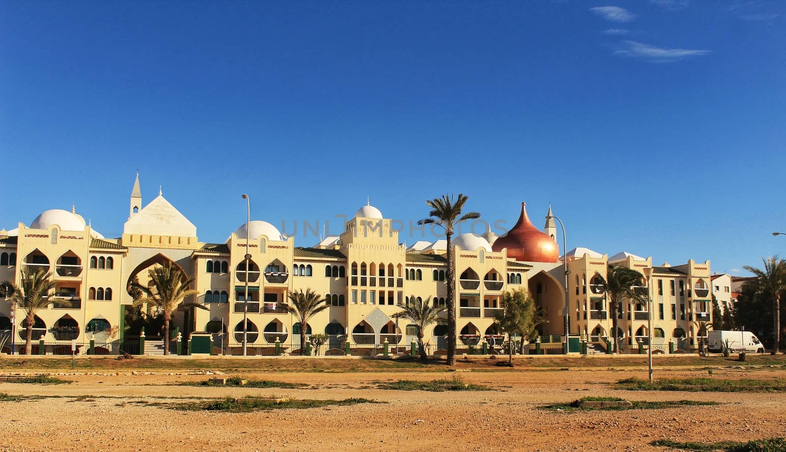 Santa Pola, Spain- February 20, 2018: Beautiful and colorful Arab-style urbanization on the coast of Santa Pola, Alicante, in a sunny day under blue sky