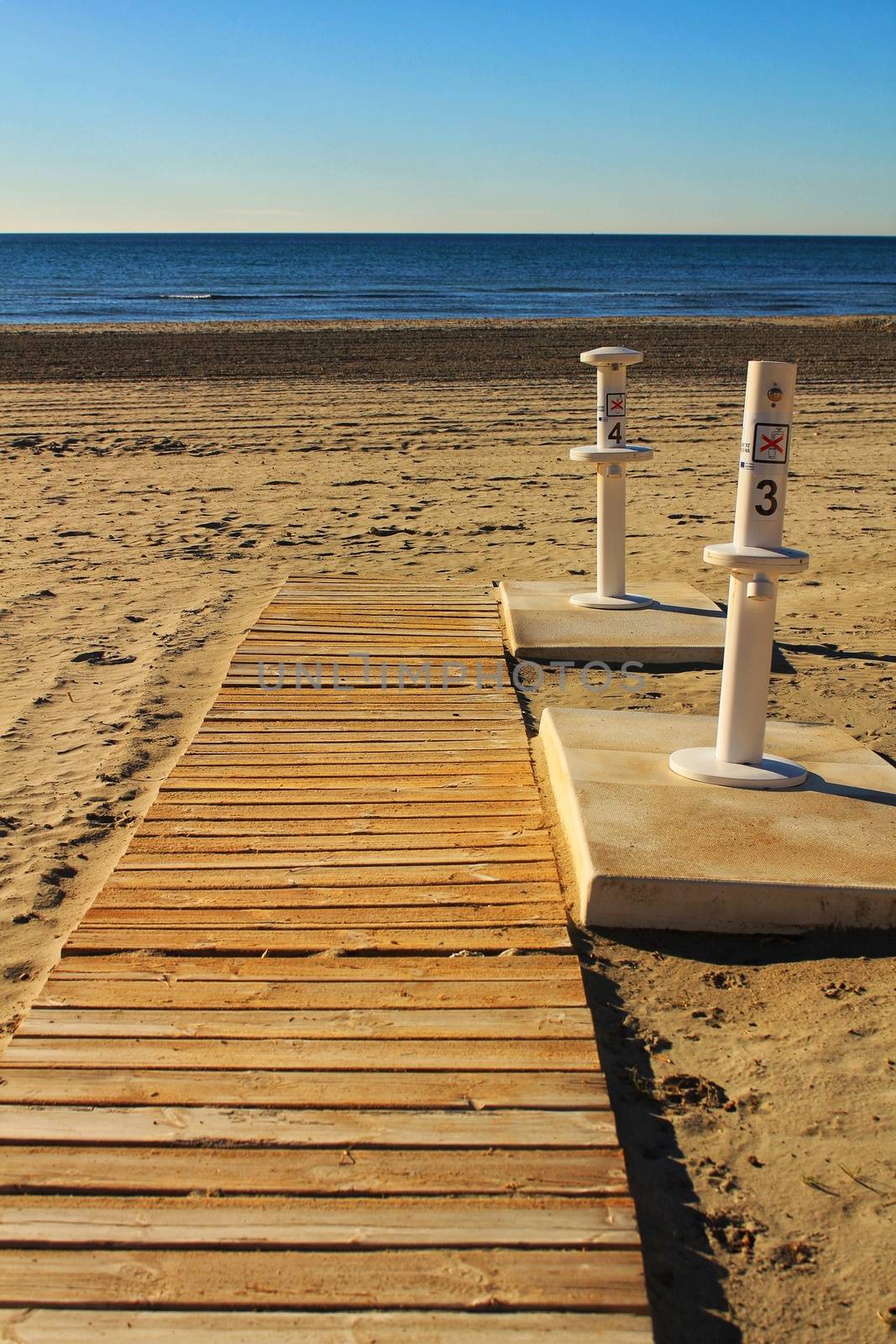 Footbath shower and walkway to the beach in the morning in a cloudy day