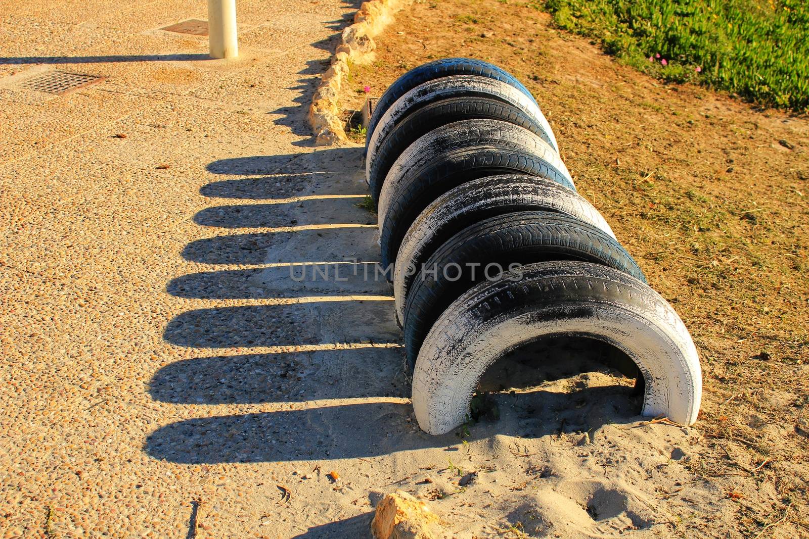 Ecological bicycle parking made with tires on the beach in Santa Pola, Spain
