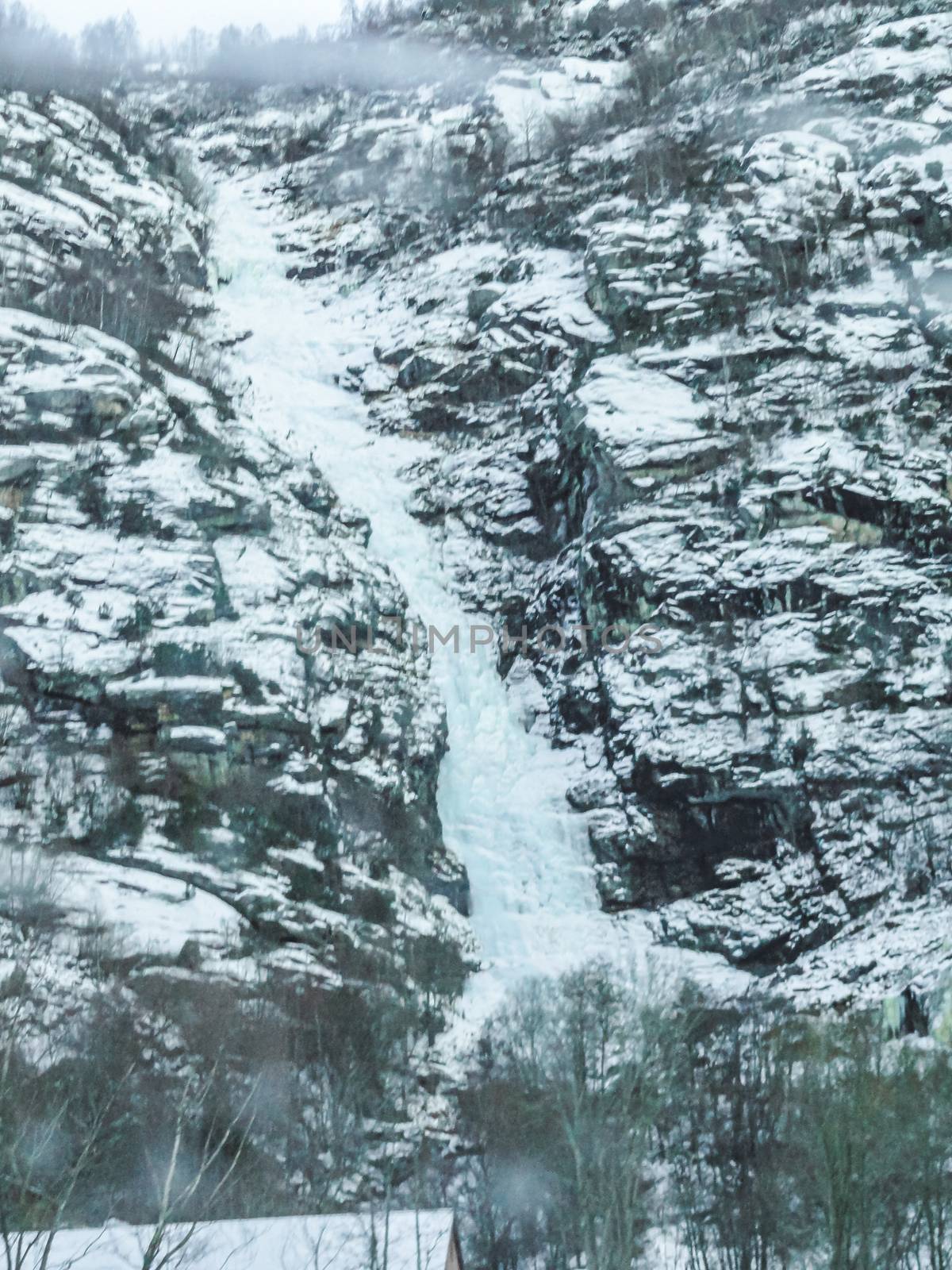 Frozen waterfall and icicles in a beautiful landscape in Norway.