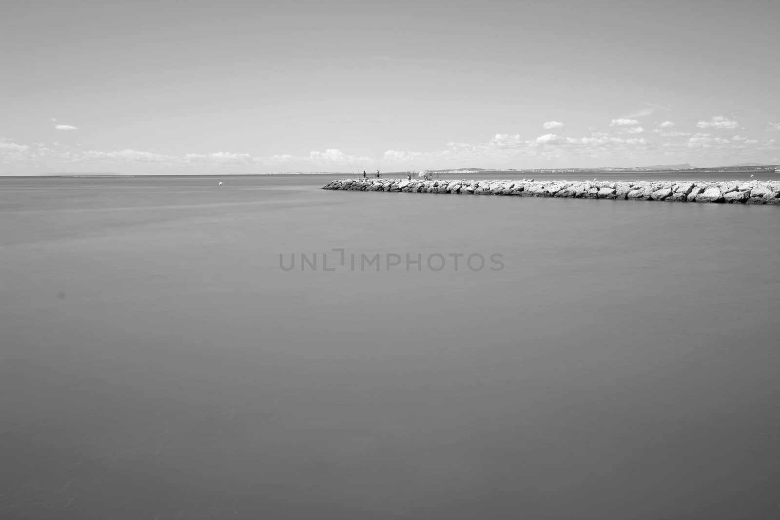 Fishing day on a breakwater under the sun in Santa Pola, Spain