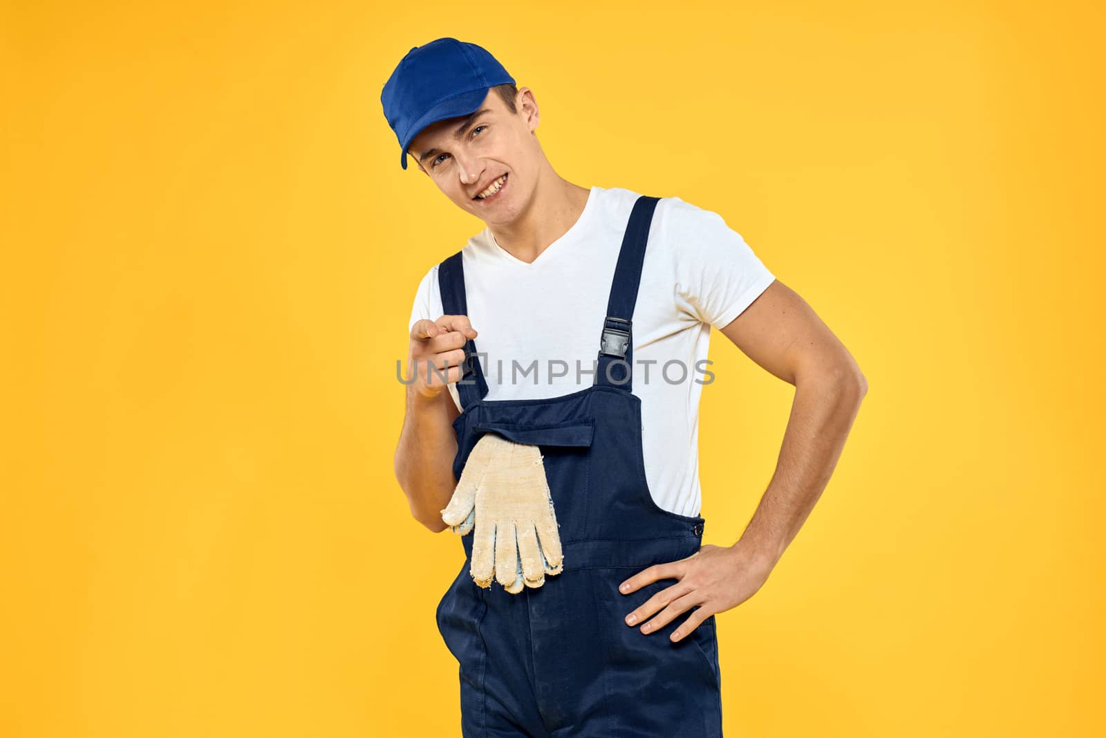 Man in working uniform emotions rendering service delivery service yellow background by SHOTPRIME