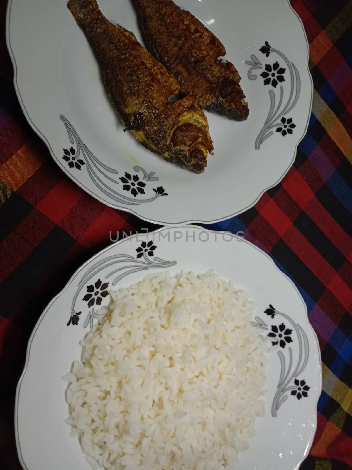 white colored Rice stock and fish on plate