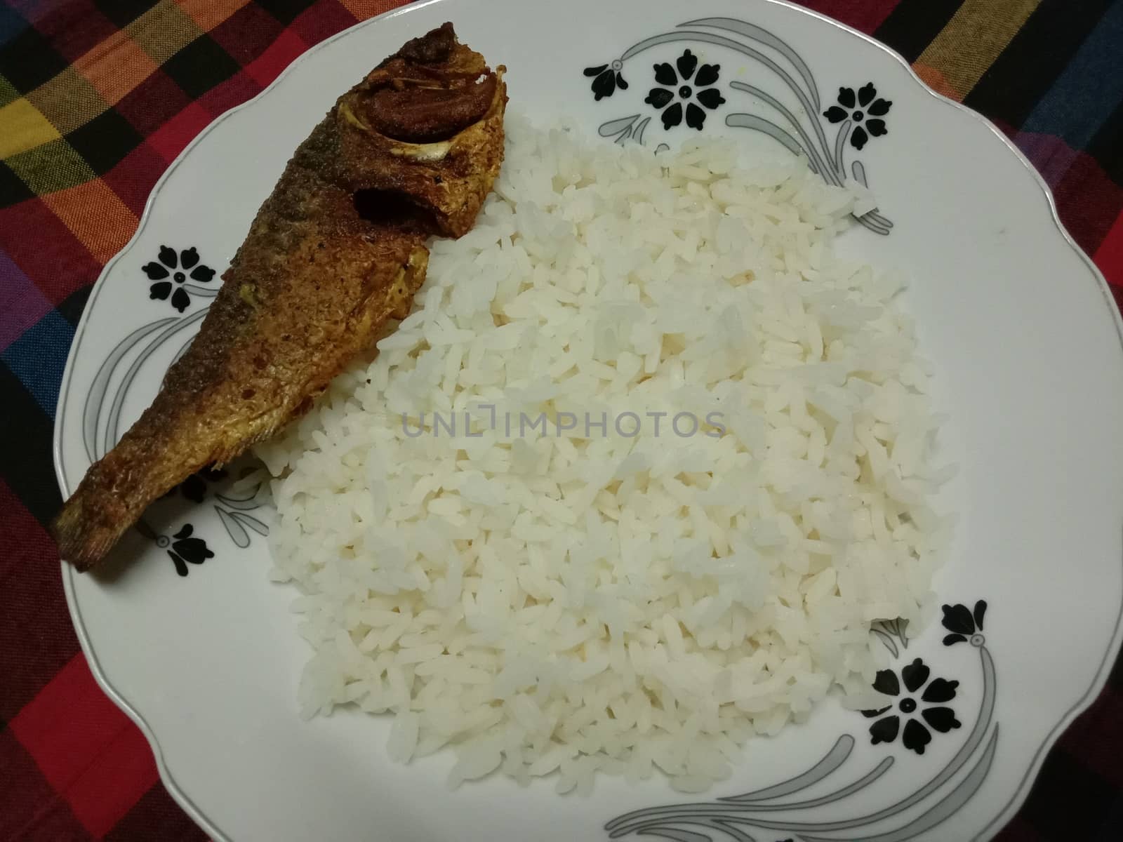 white colored Rice stock and fish on plate