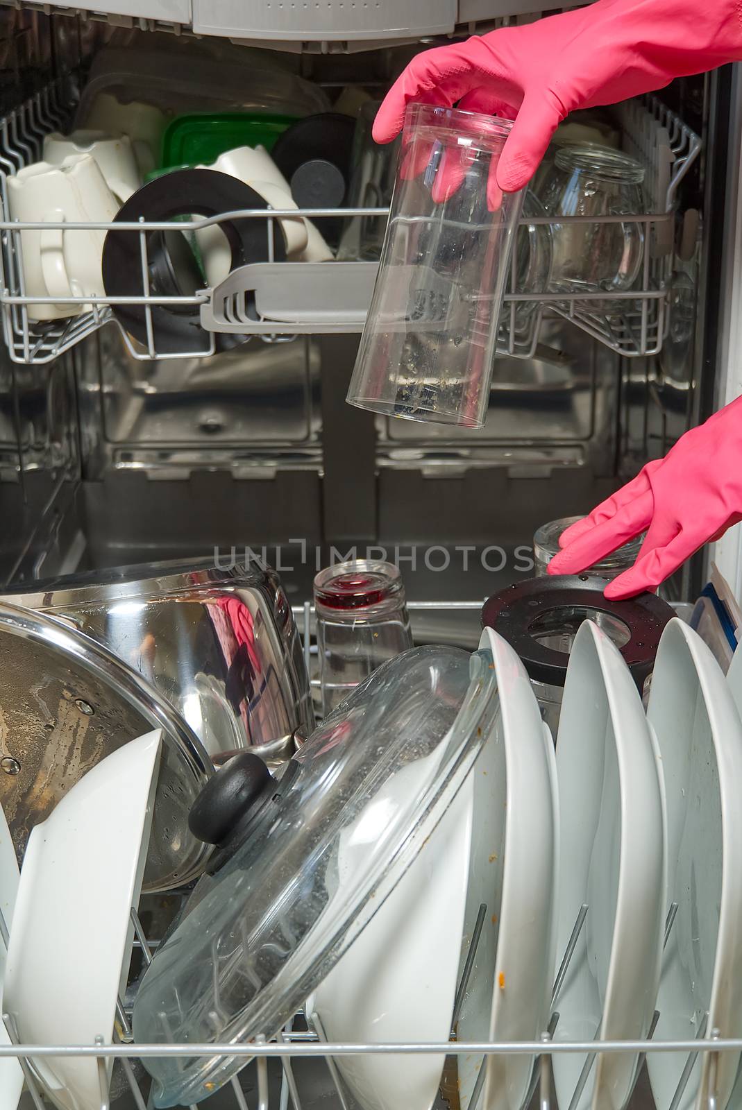 Dirty dish in open integrated dishwasher. Open dishwasher with dirty dishes inside before washing. full loaded dishwasher ready for washing. by PhotoTime