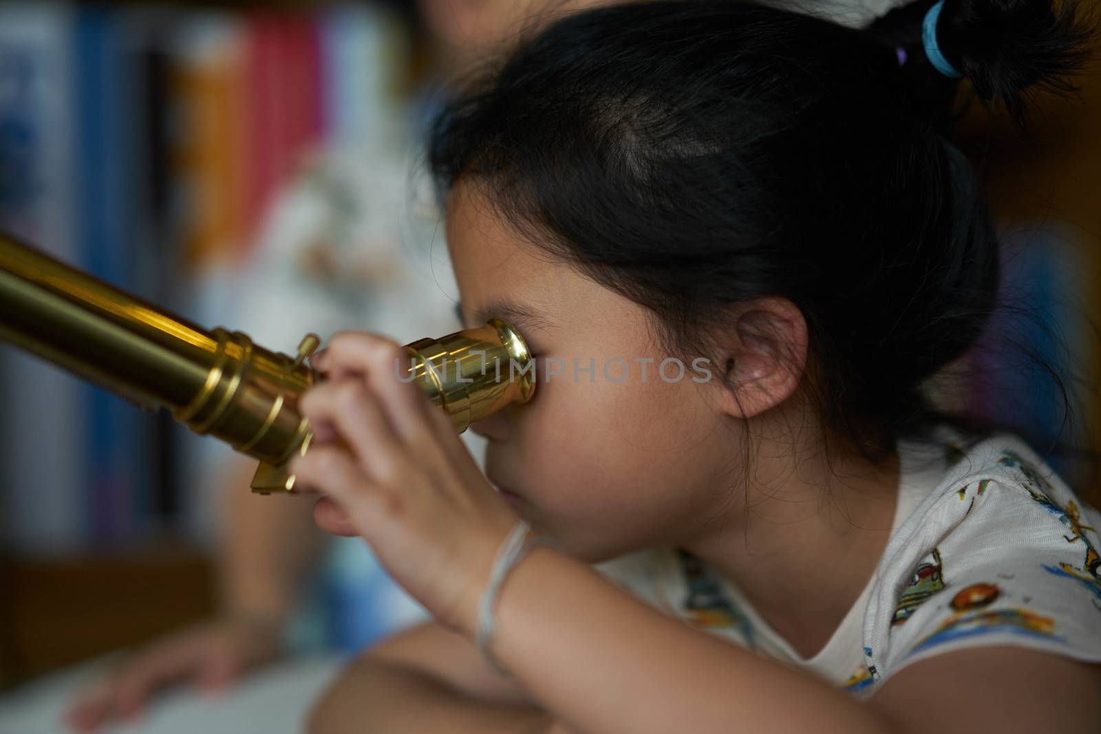 Girl use telescope alone
