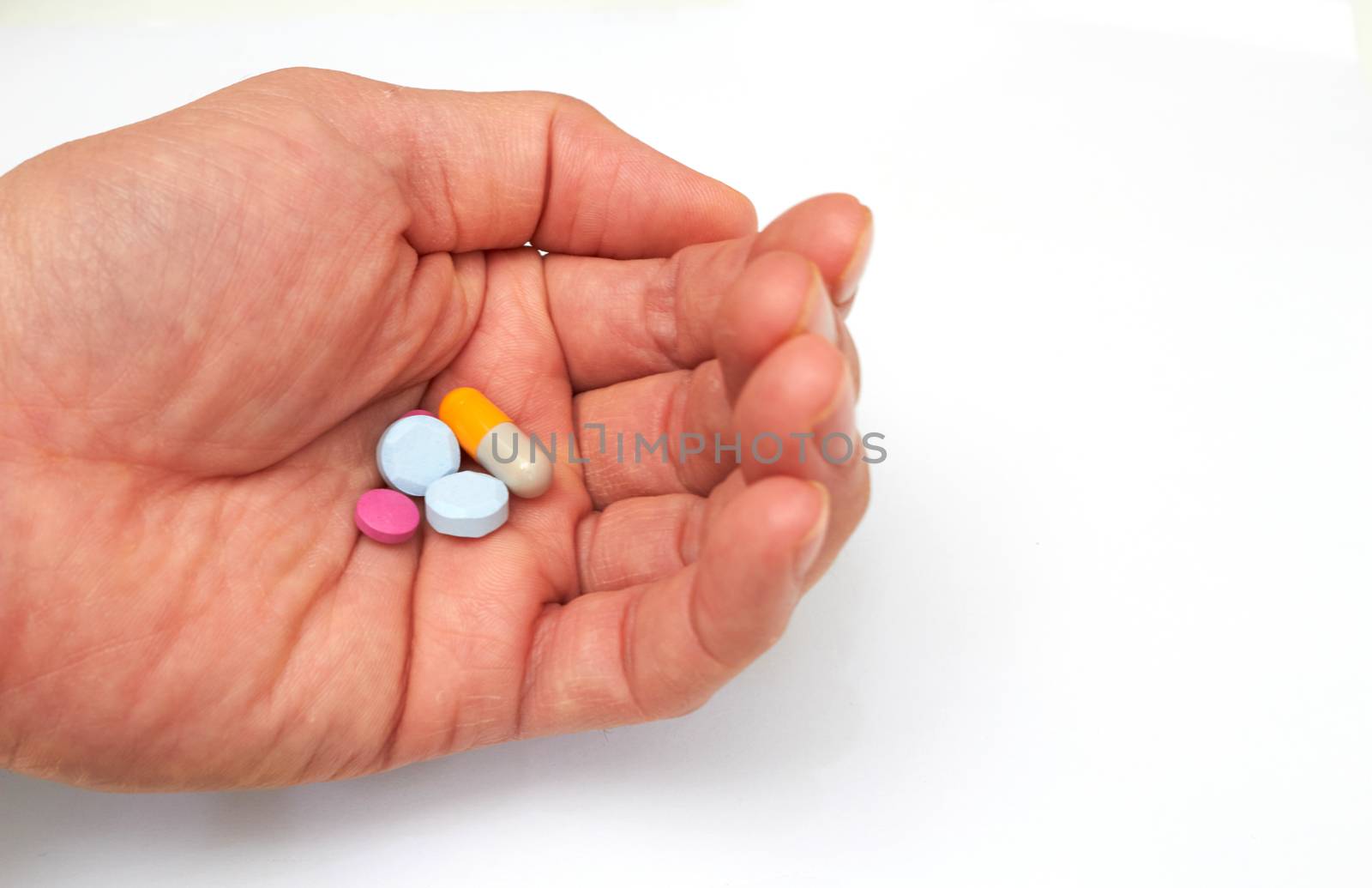 Hand holded medical pills before  oral take in medical healthcare consumption concept with copy space