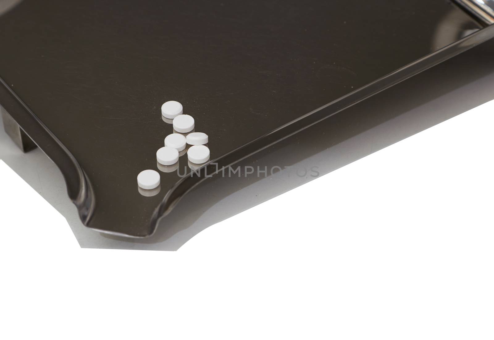 white medical tablets on counting drug tray