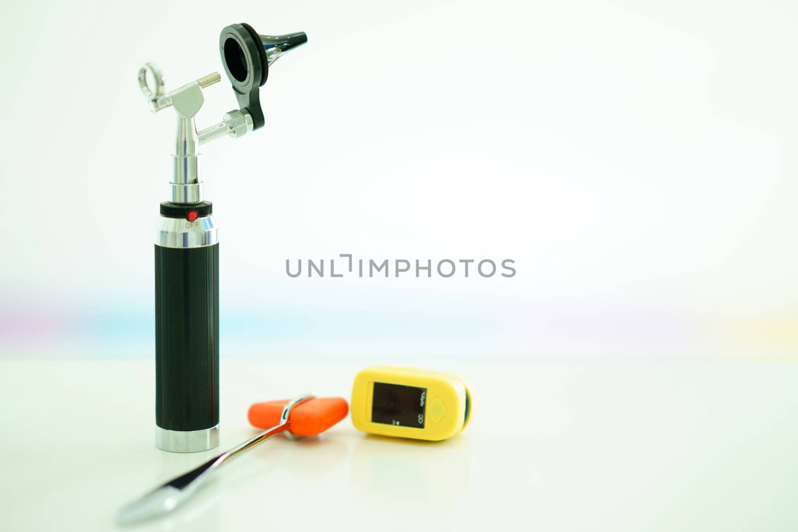 light Otoscope ,Hammer jerk and digital Oxymeter on blur background.jpg