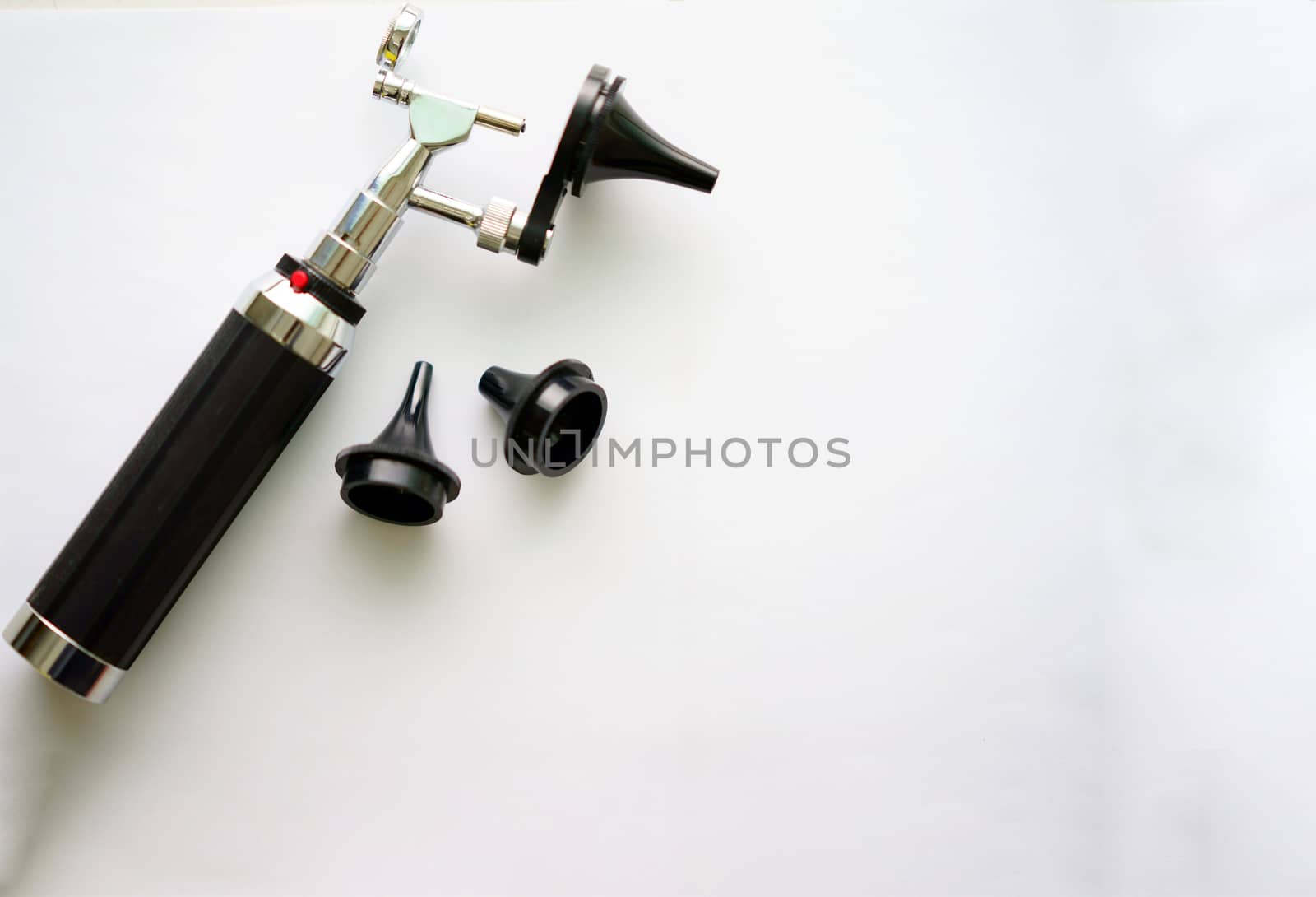 Otoscope for ear check for doctor ENT  with three sizes of specula pieces on blur background with copy space