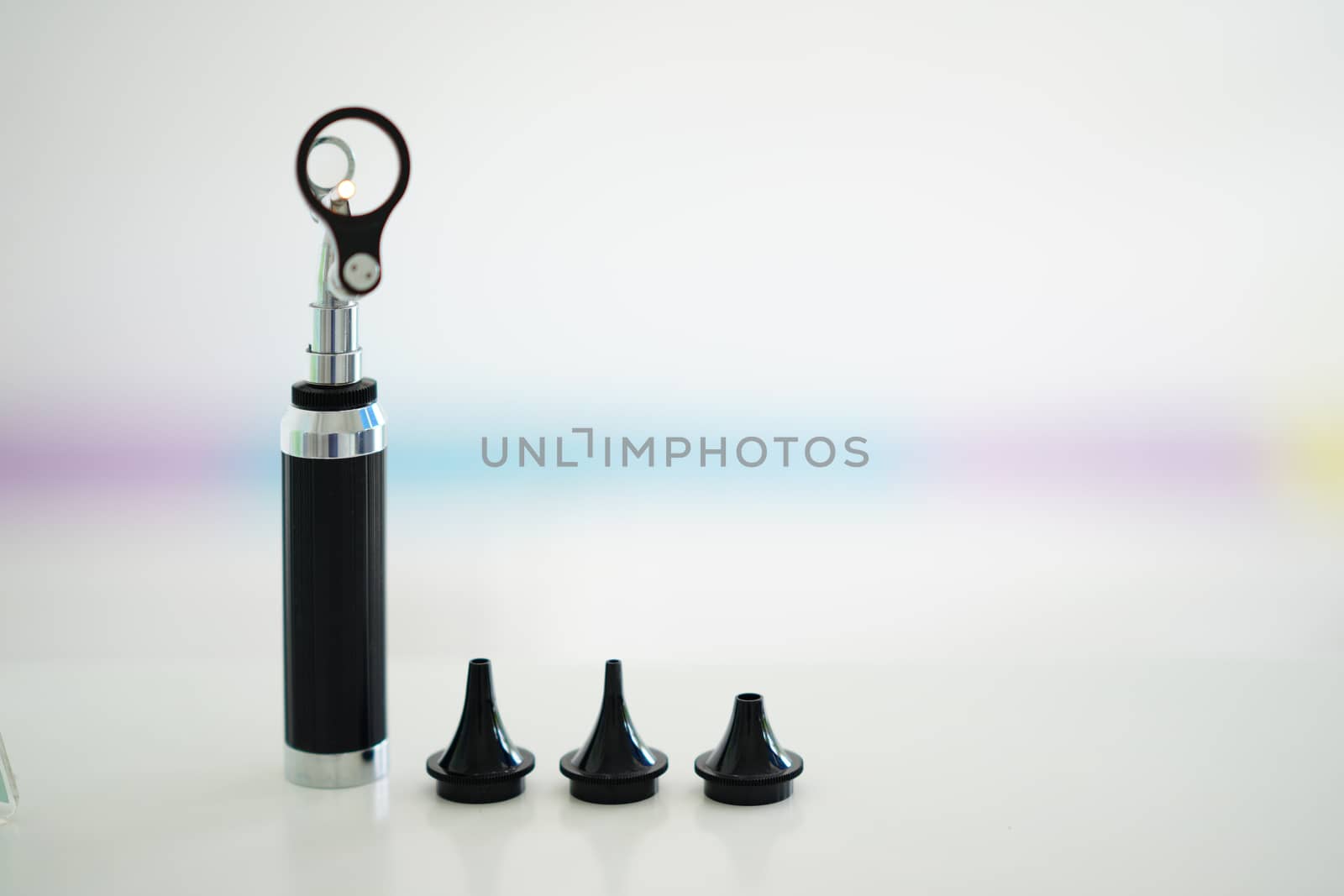 Otoscope for ear check for doctor ENT  with specula pieces on blur background with copy space