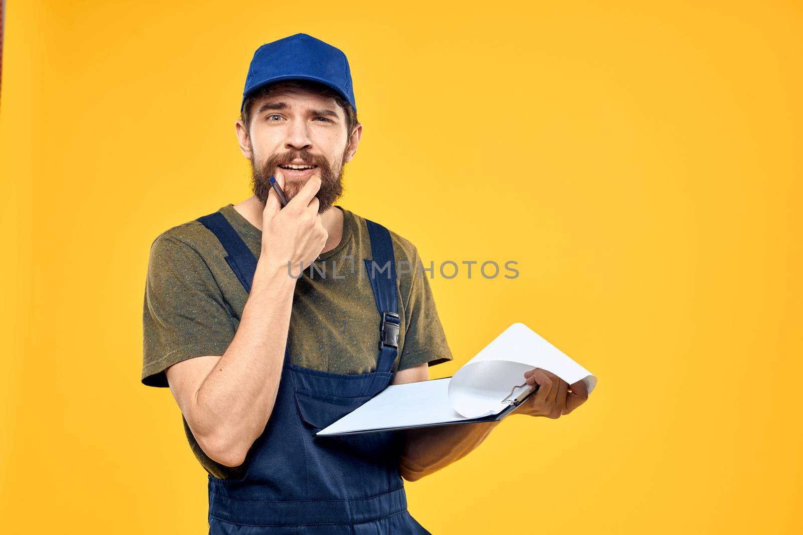 Man in working form documents transportation delivery service yellow background by SHOTPRIME