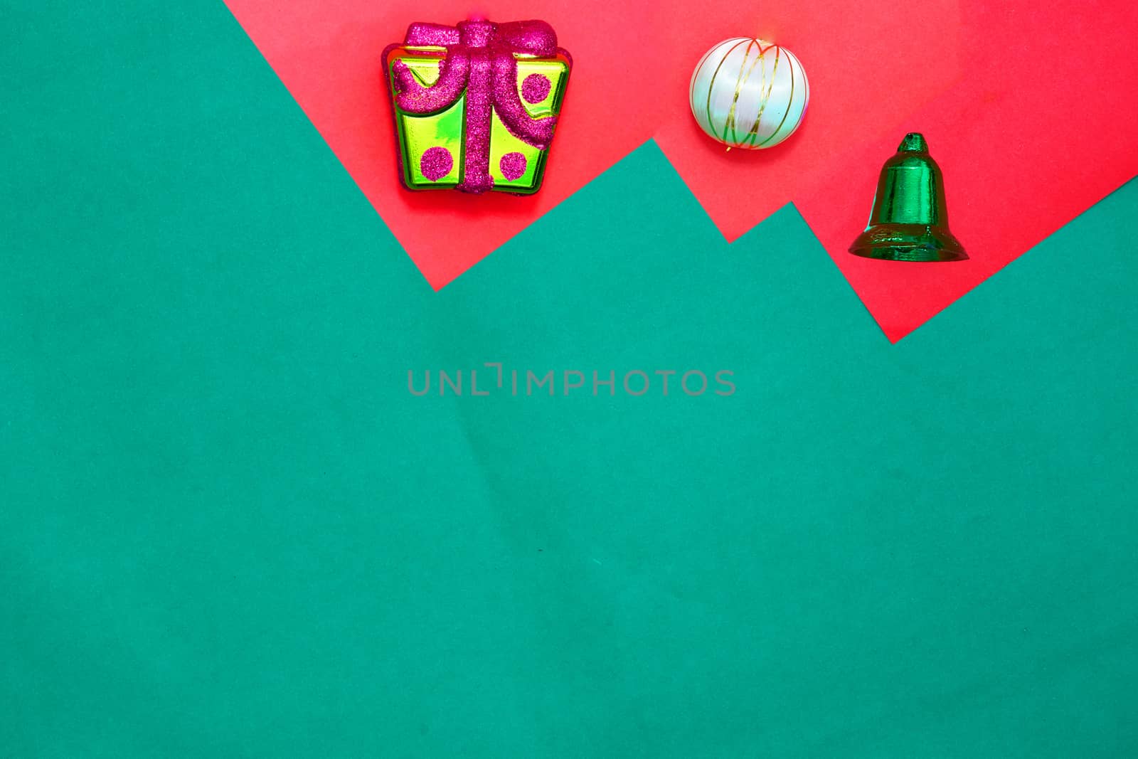 present box ,bauble and green ring on red and green background with copy space for new year and christmas time