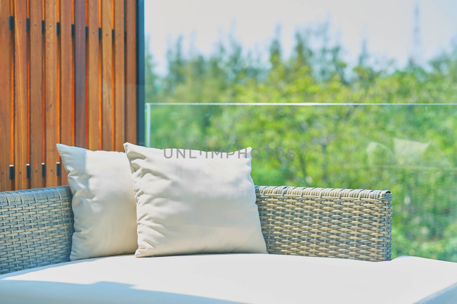 sofa with pillows in sunlight ,outdoors by VacharapongW