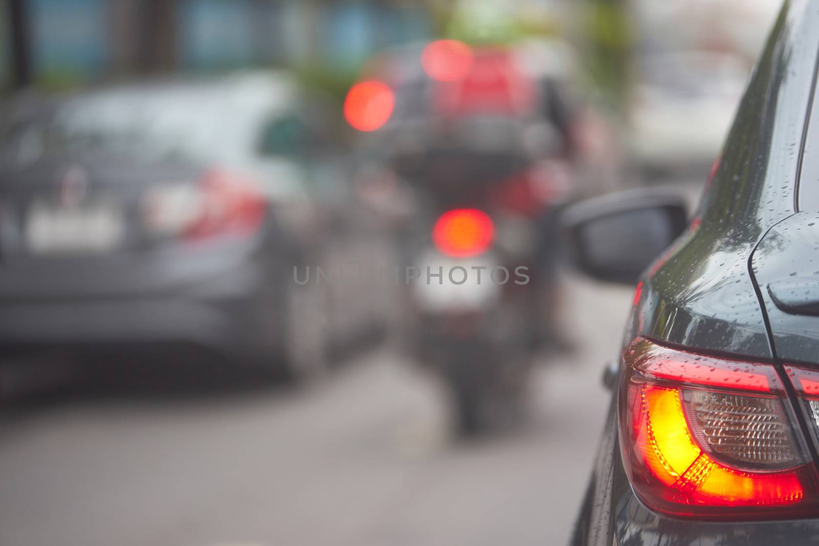 Taillight or rear lamp of car on blur traffic street view background