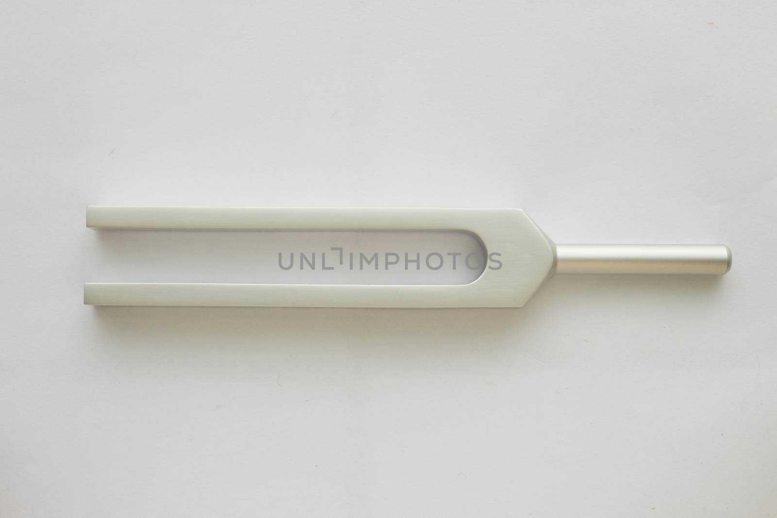 Tuning fork for ear test of ENT doctor or sound wave maker on white background