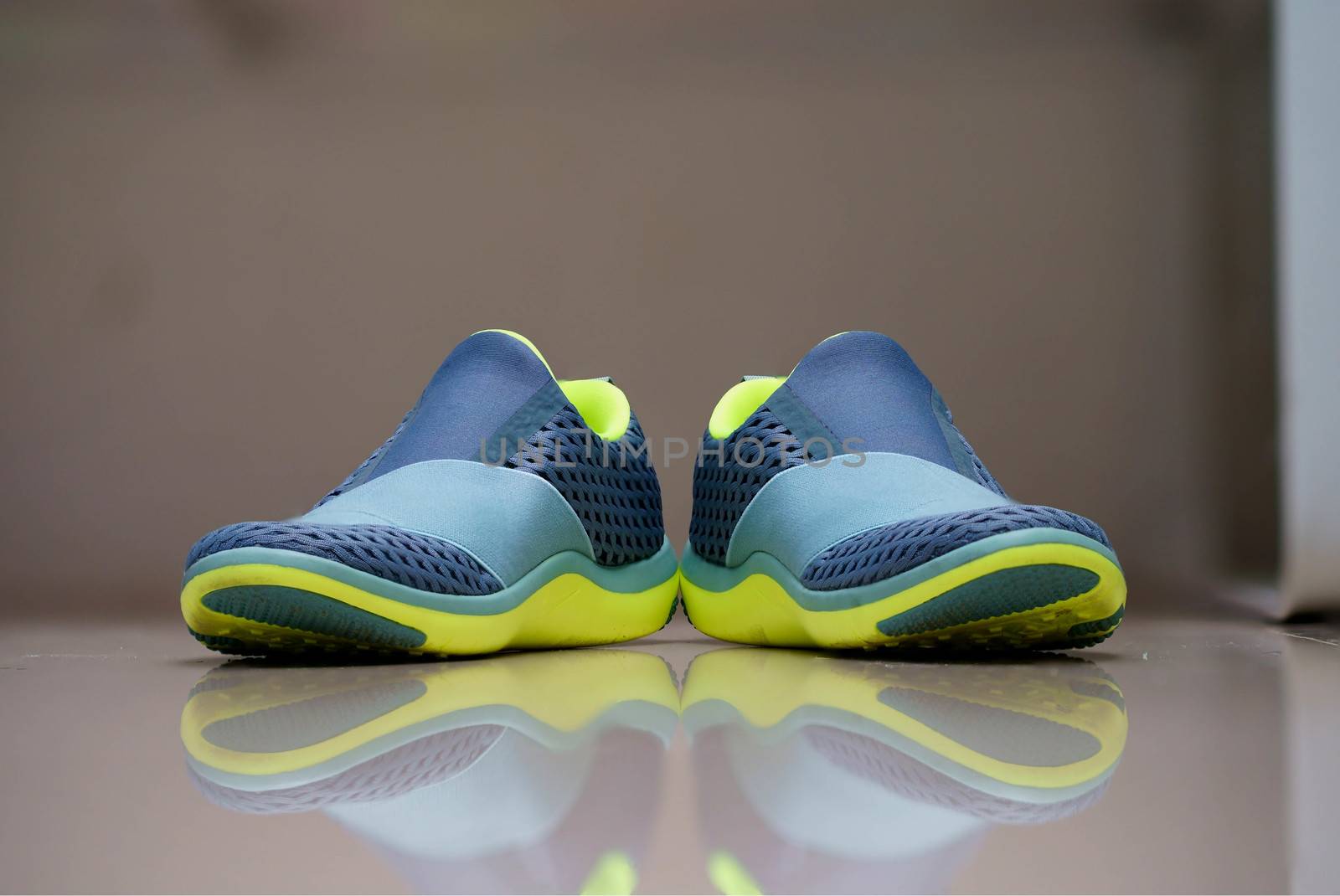 woman running shoes without string on blur background with reflection