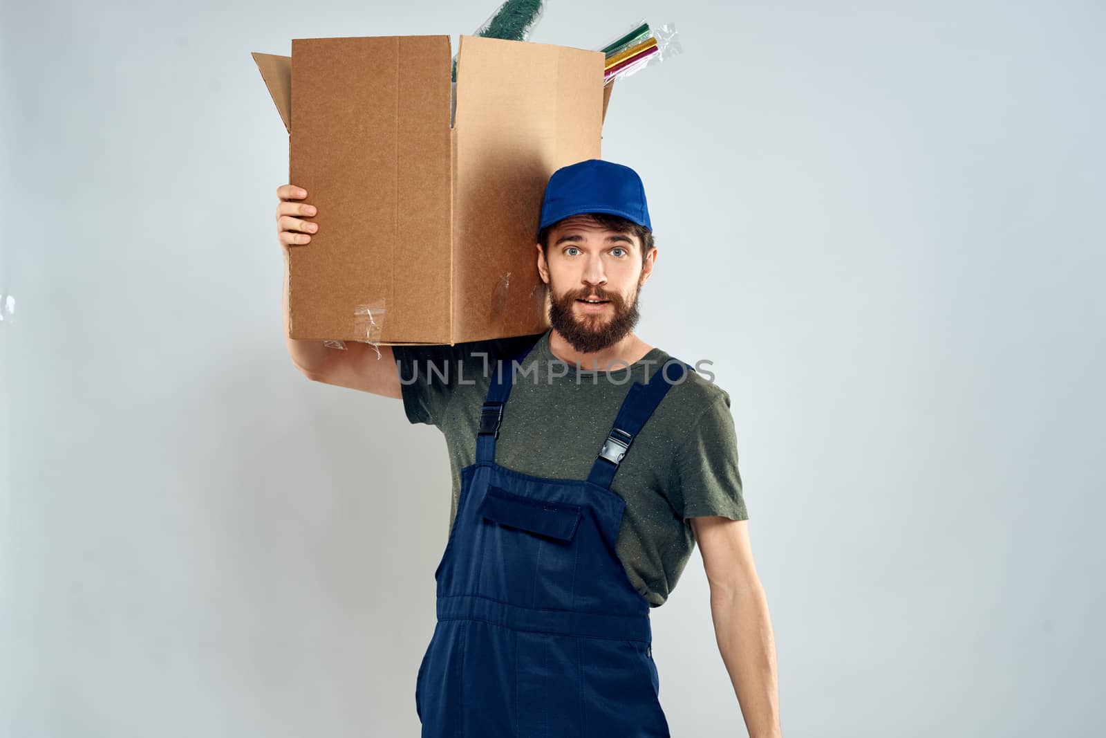 Male worker loading delivery boxes in hands packing lifestyle. High quality photo