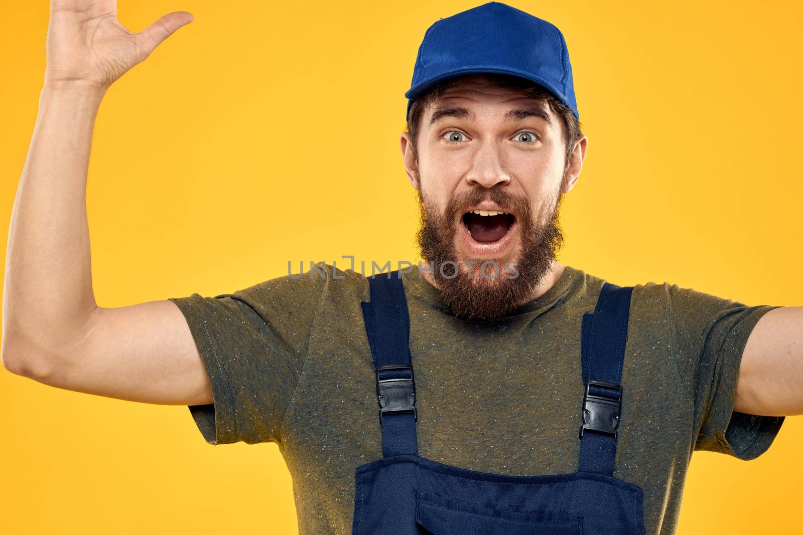 Worker man in uniform worker service yellow background emotion by SHOTPRIME