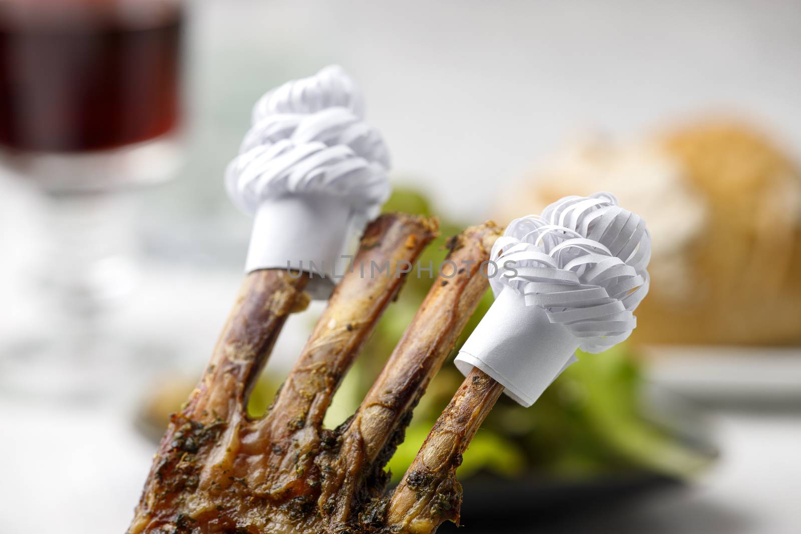 lamb ribs with frills and salad