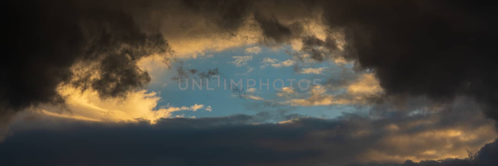 Panorama dramatic clouds illuminated rising of sun floating in sky. Natural weather, meteorology background. Soft focus, motion blur sky natural meteorology cloudscape.