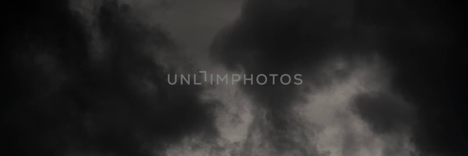 Panoramic view of dramatic thunderstorm clouds in dusk sky during rain. Natural cloudiness weather background. Soft focus, motion blur sky natural meteorology cloudscape.