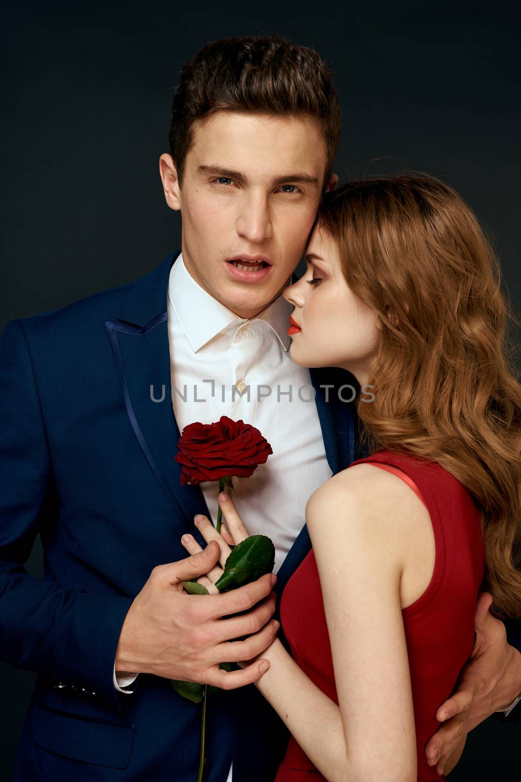 luxury couple hug romance relationship rose over dark isolated background. High quality photo