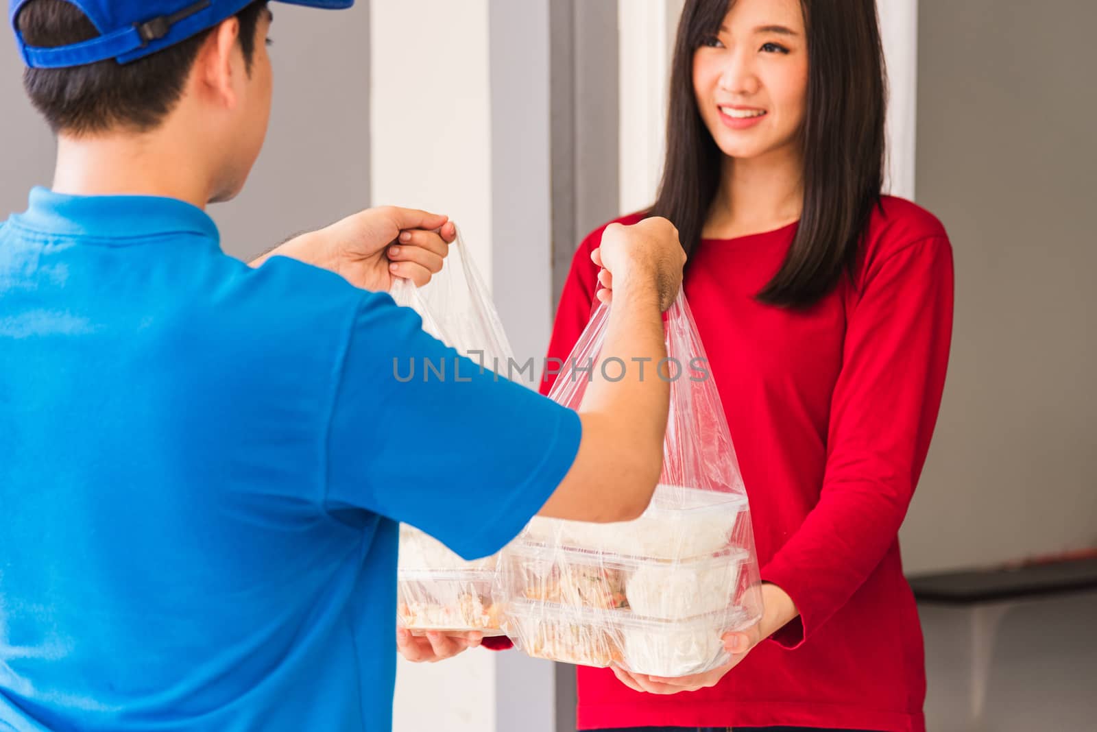 Delivery man making grocery service giving rice food boxes plast by Sorapop