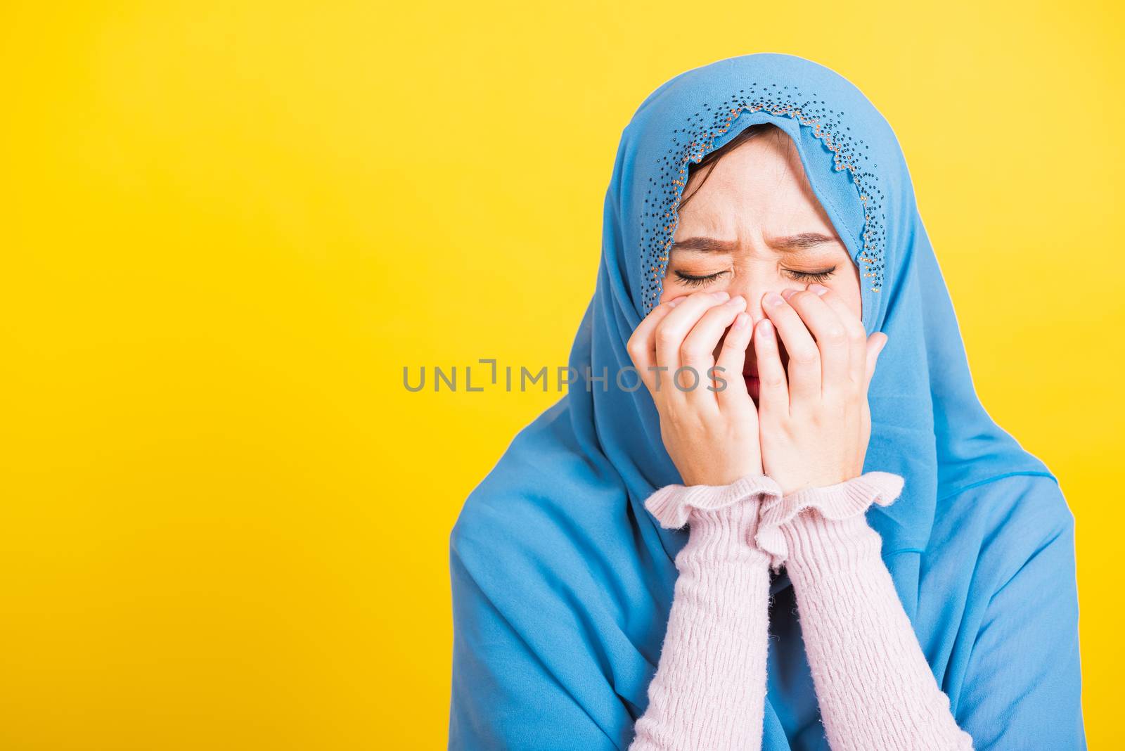 Woman wear veil hijab she sad crying using hand wiping tears in  by Sorapop