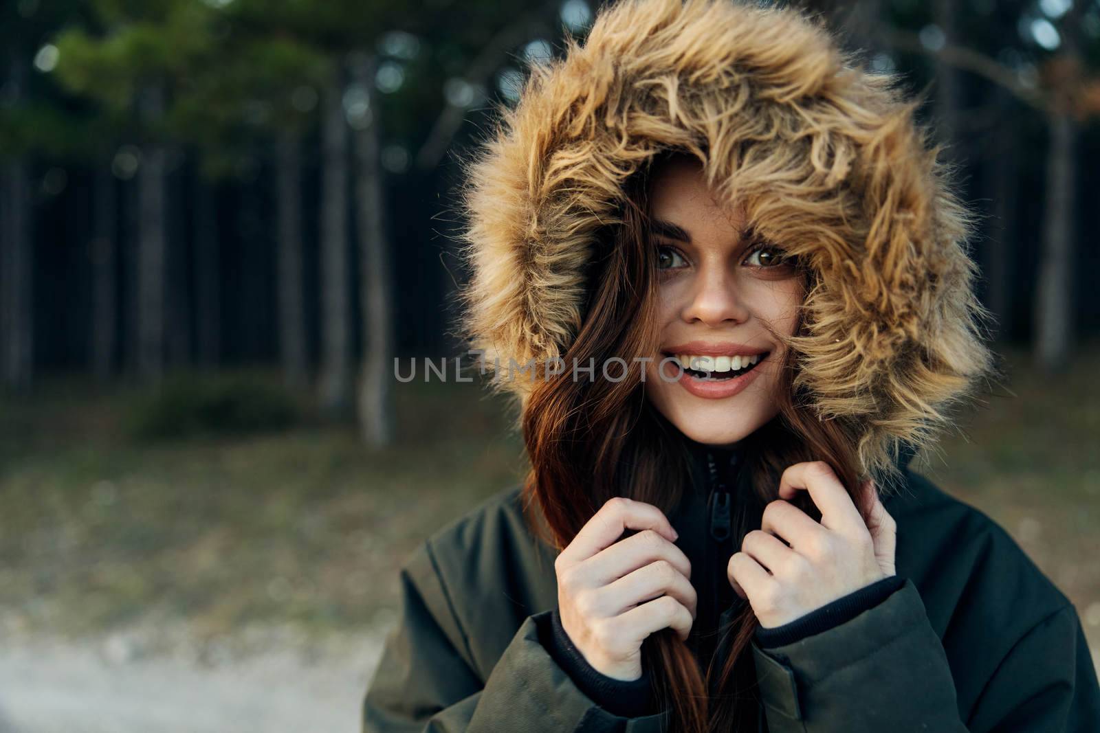 Cheerful woman in a jacket with a hood nature lifestyle look ahead. High quality photo