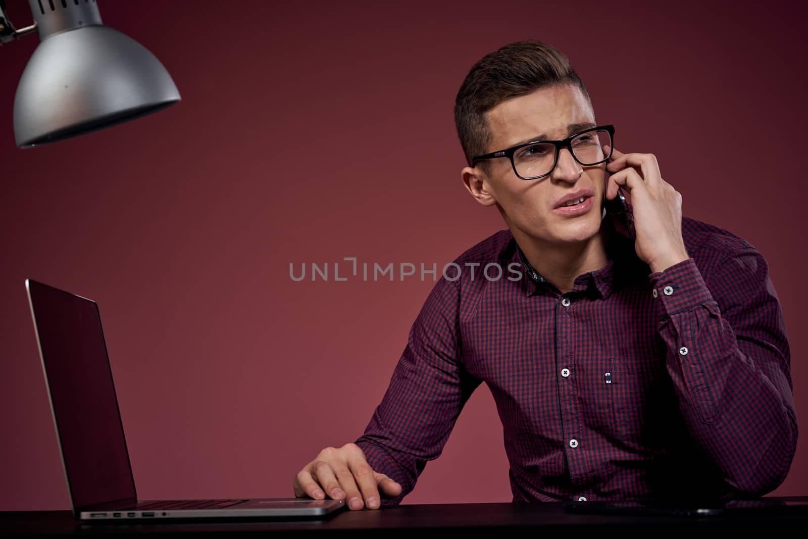Business man in office and talking on the phone manager red background model cropped view of laptop tablet by SHOTPRIME