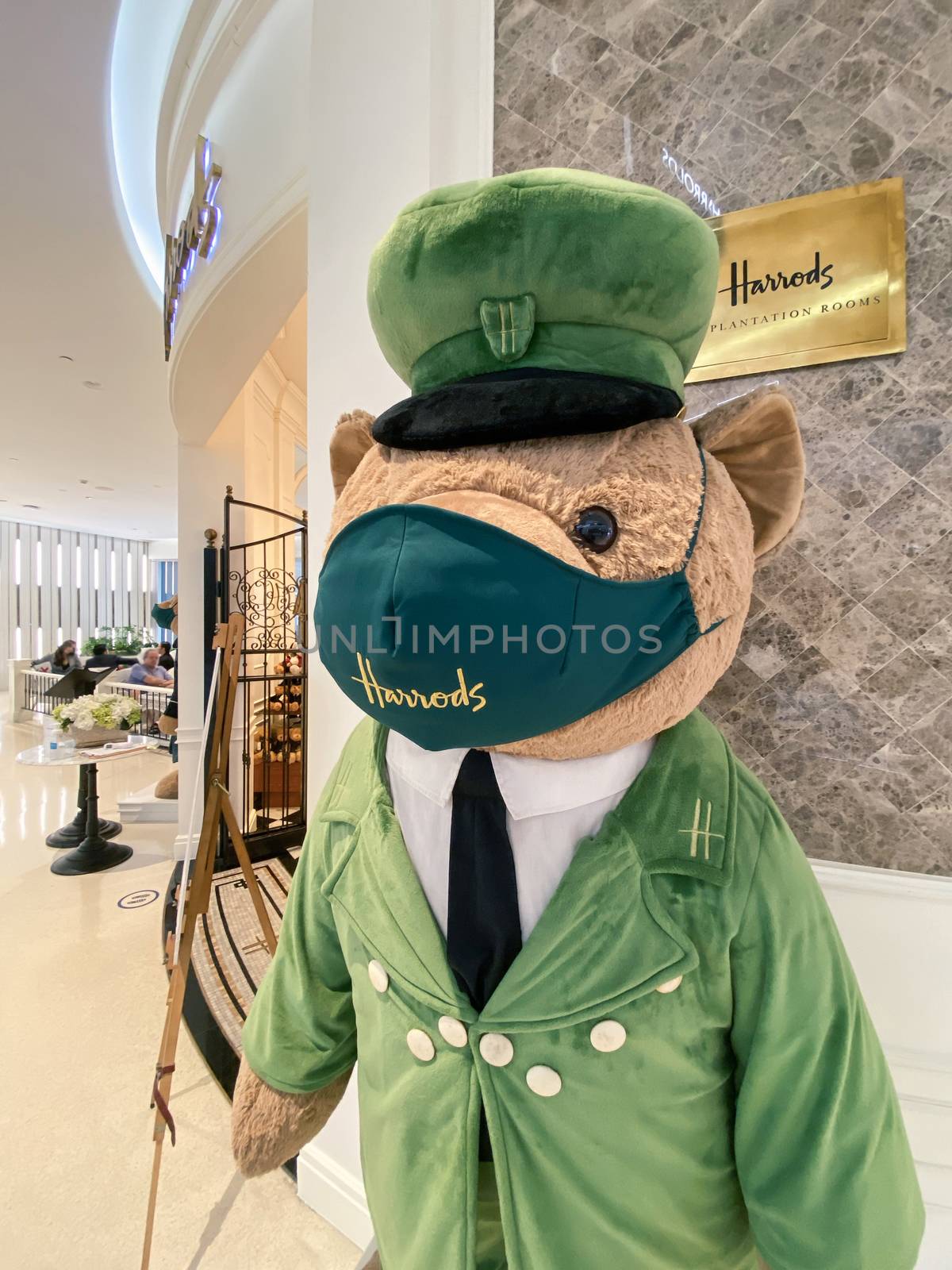 Harrods Teddy Bear (Greenman Bear) waring mask during Covid-19 pandemic at entrance of famous Harrods store in Central Embassy, Bangkok, Thailand