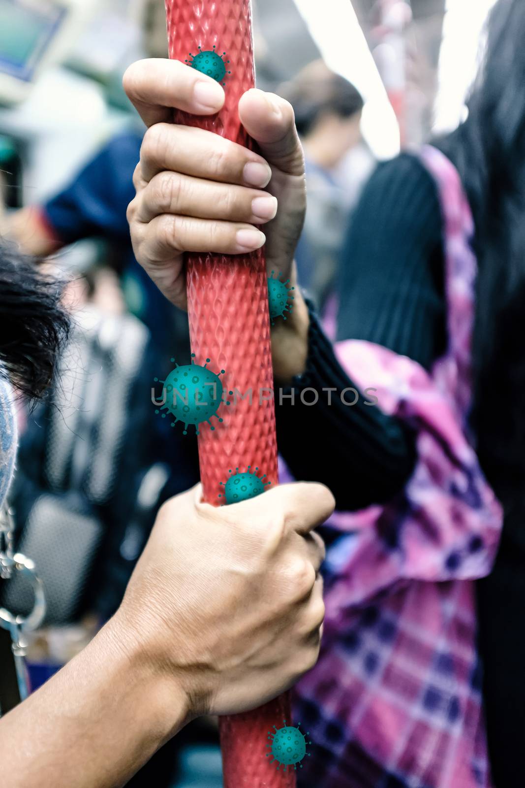 passenger hands holding handle in public transportation like subway, skytrain and bus with virus or germ effect during COVID-19 situation, concept of preventing pandemic spread, shallow depth of field