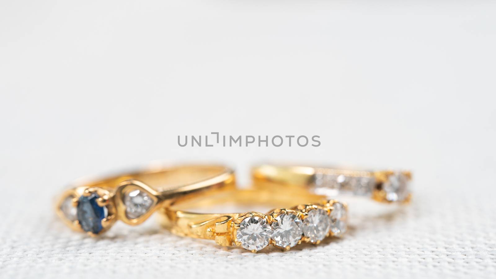 Group of diamond ring on white sack background.