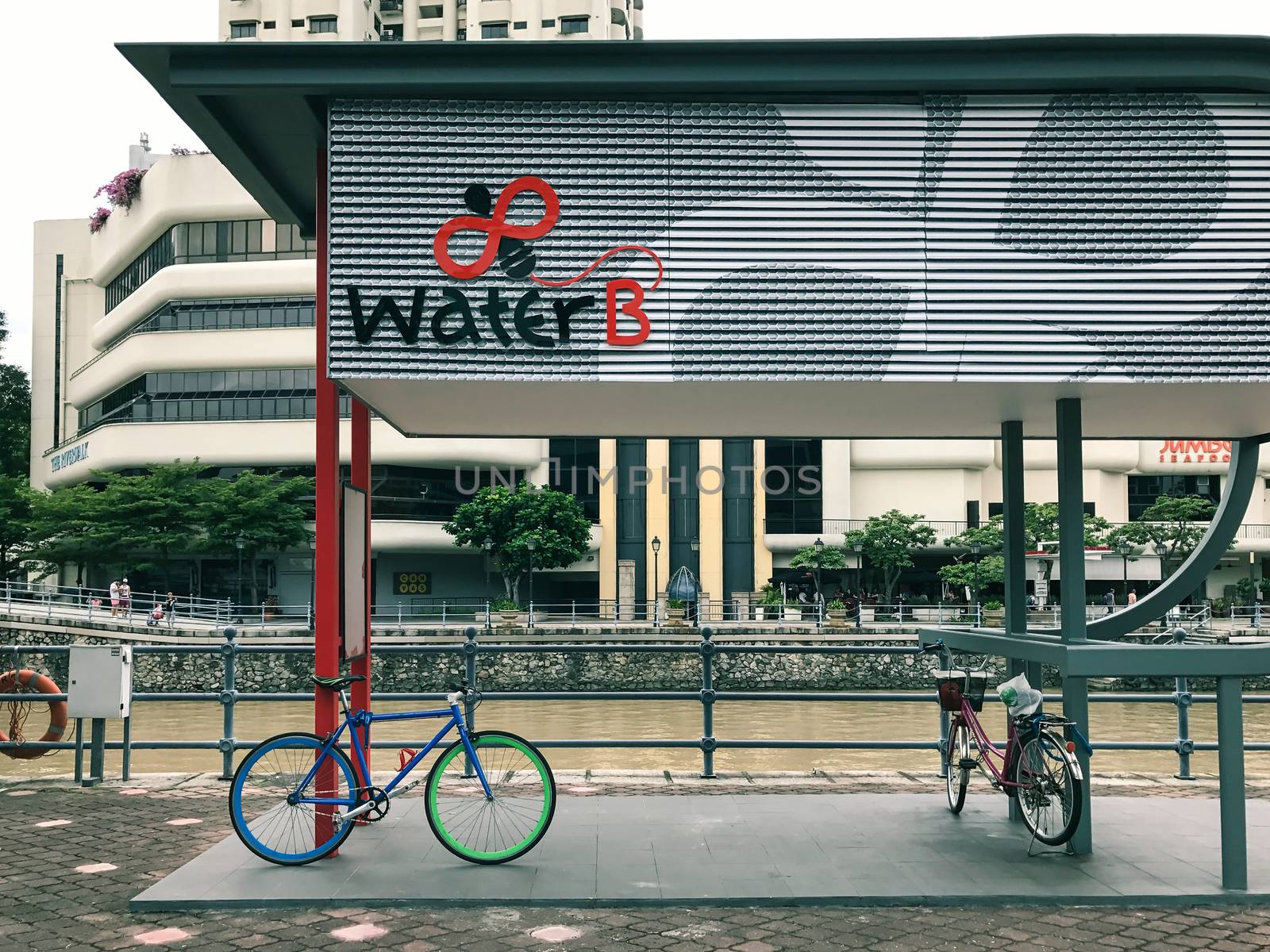 Bicycle parked at Water B ticketing kiosk for Singapore River Cruise by the river in Singapore city.  It is a good way to explore many iconic landmarks of Singapore city.