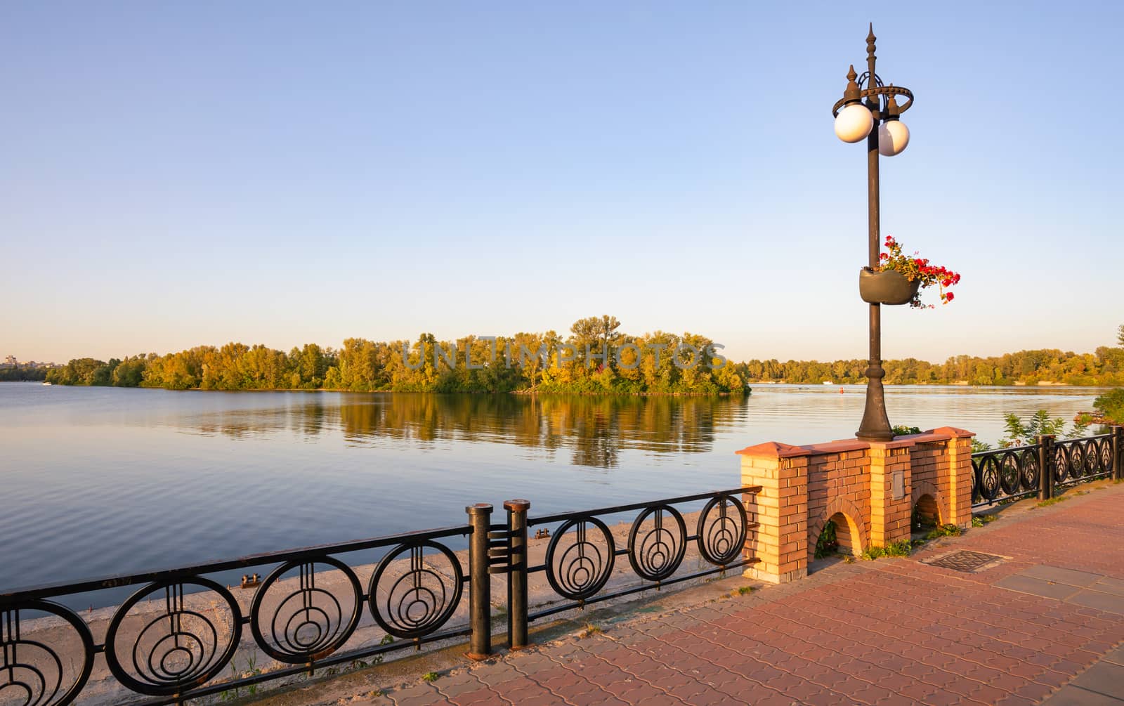 Promenade along the Dnieper River in the Obolon district of Kiev, Ukraine, on a sunny summer evening