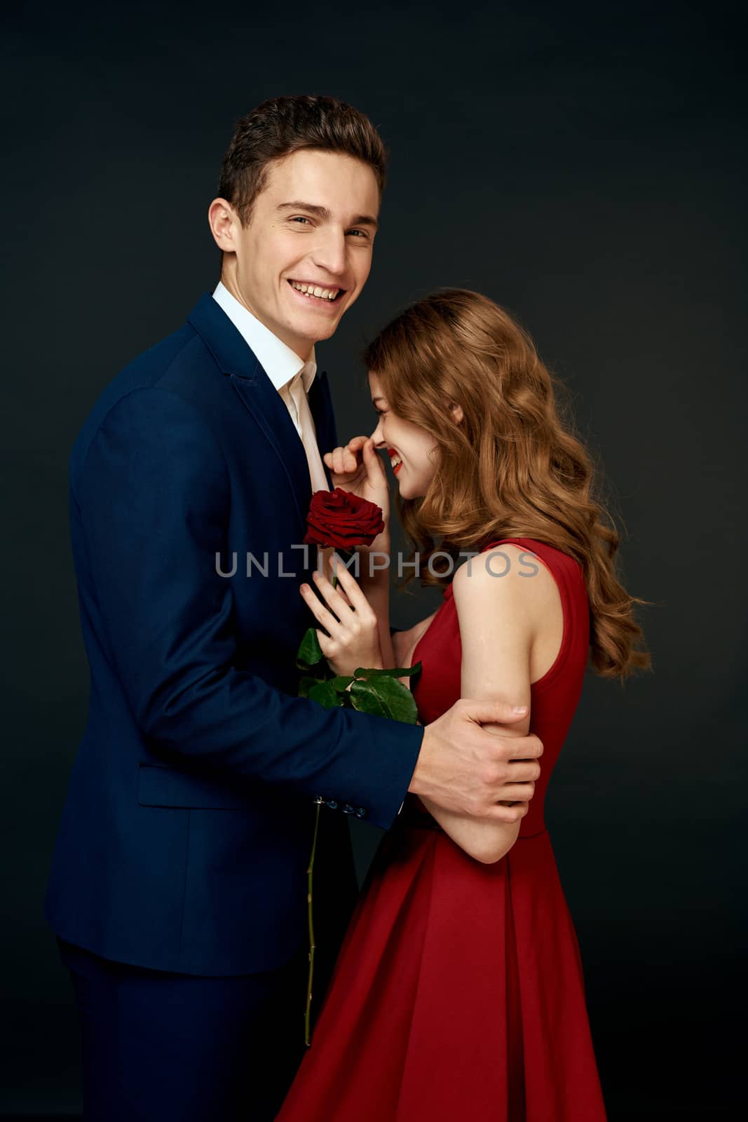 Beautiful couple charm hug lifestyle relationship rose luxury dark background. High quality photo