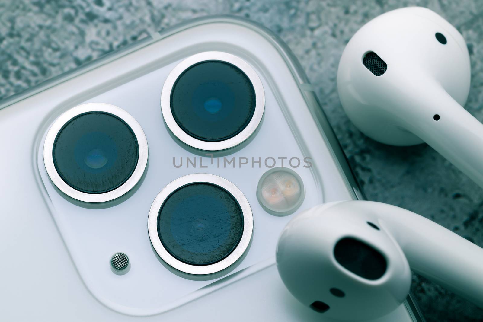 Close up shot for scratch on iPhone11 Pro Max rear camera lens, the triple camera system of ultra wide, wide and telephoto lenses. iPhone11 Pro Max and Airpods