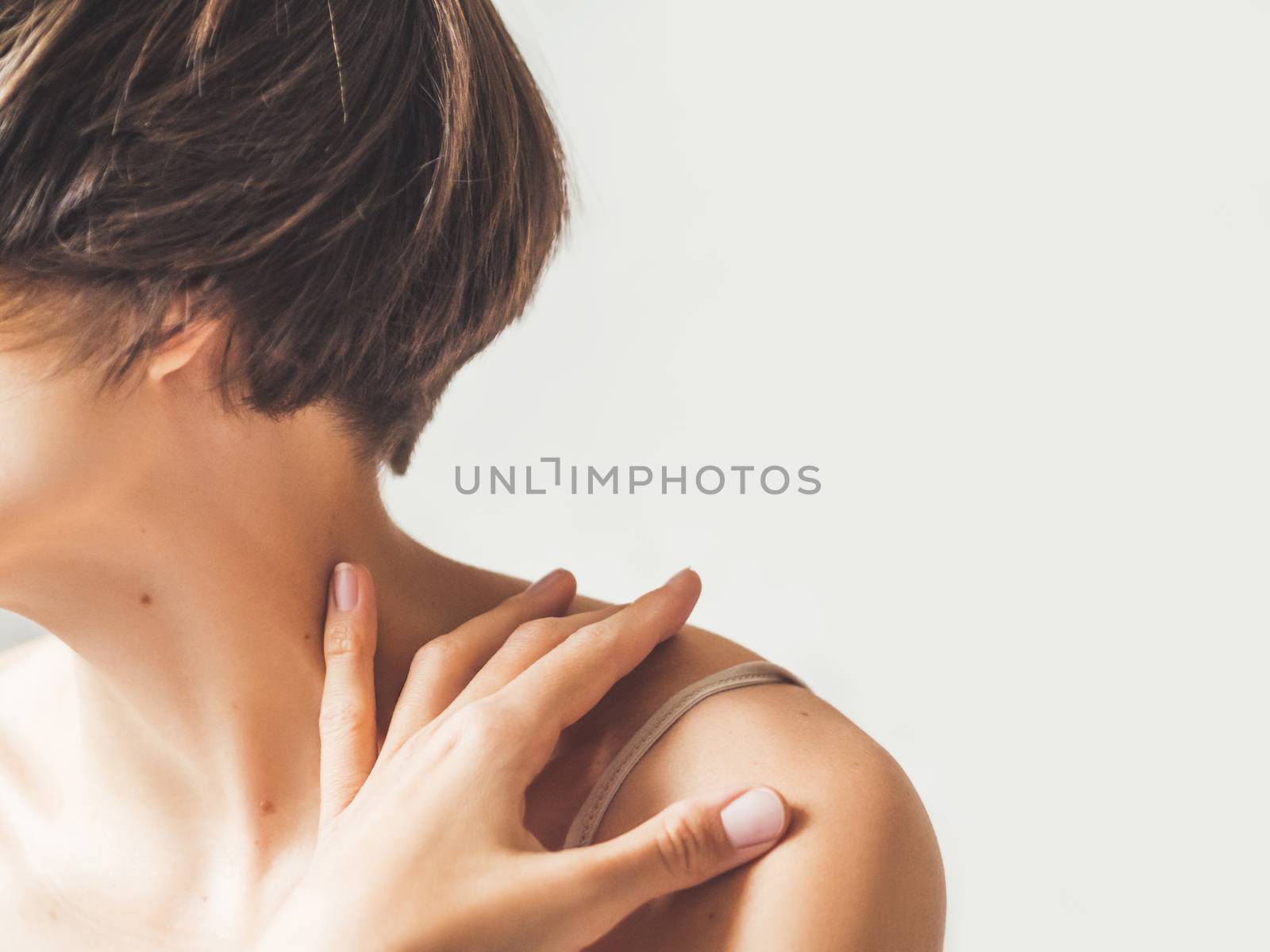 Close up portrait of woman with short hair cut on white background. Natural beauty without make up.